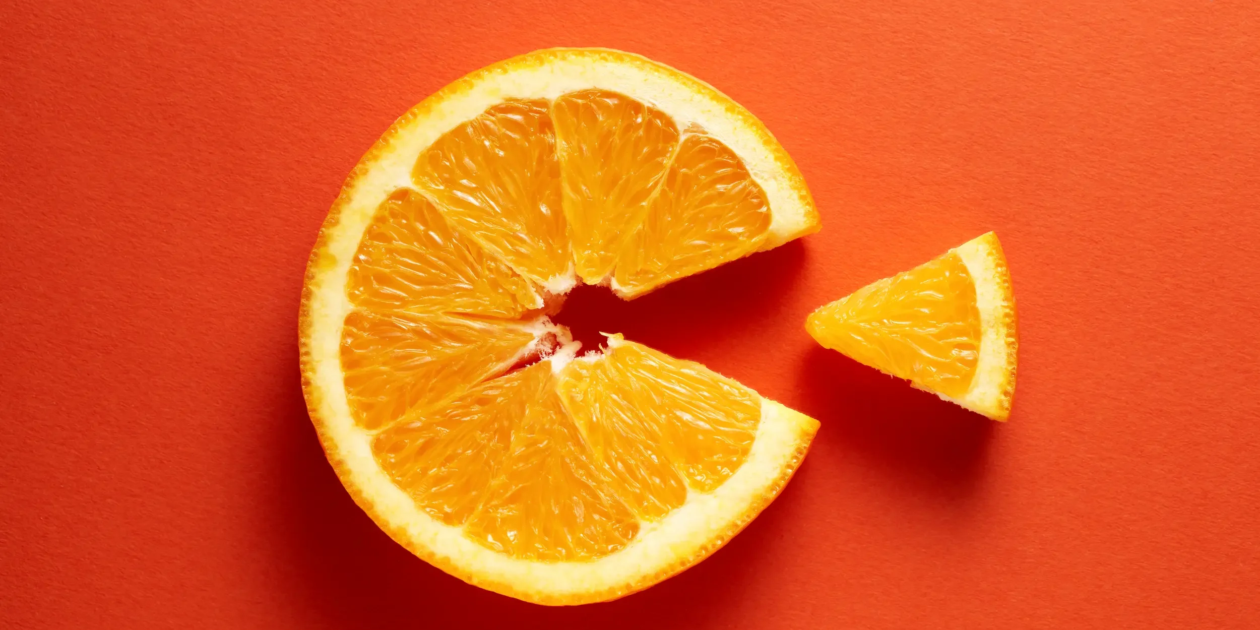 A flat slice of orange with one segment removed to make a ‘C’ shape.