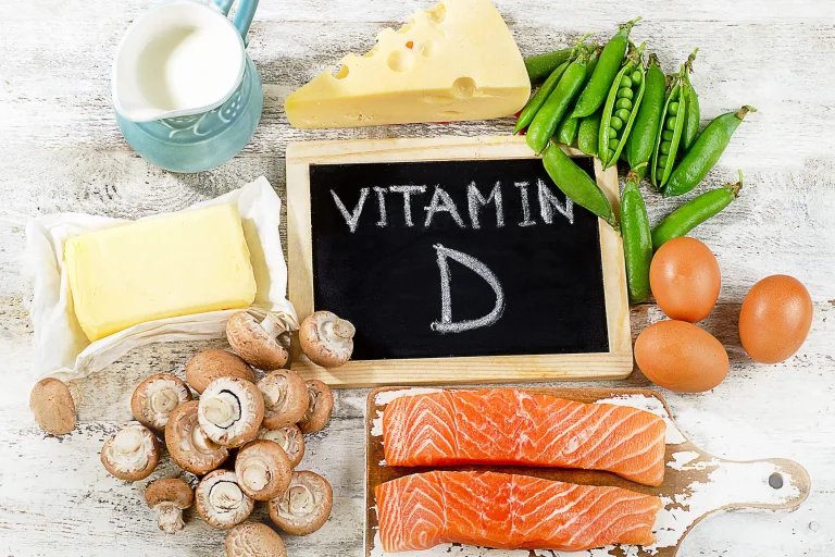 Which Foods Contain Vitamin D A spread of healthy foods, including some that are high in vitamin D, around a chalkboard that reads ‘vitamin D’.
