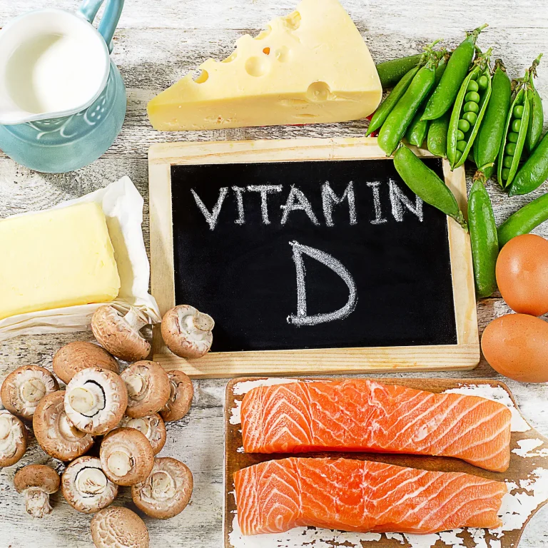 Which Foods Contain Vitamin D A spread of healthy foods, including some that are high in vitamin D, around a chalkboard that reads ‘vitamin D’.