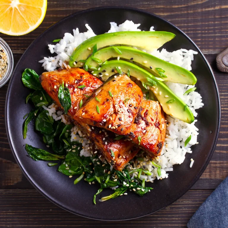 A tasty, home-cooked and nutrient-rich meal of salmon teriyaki rice with avocado and spinach.