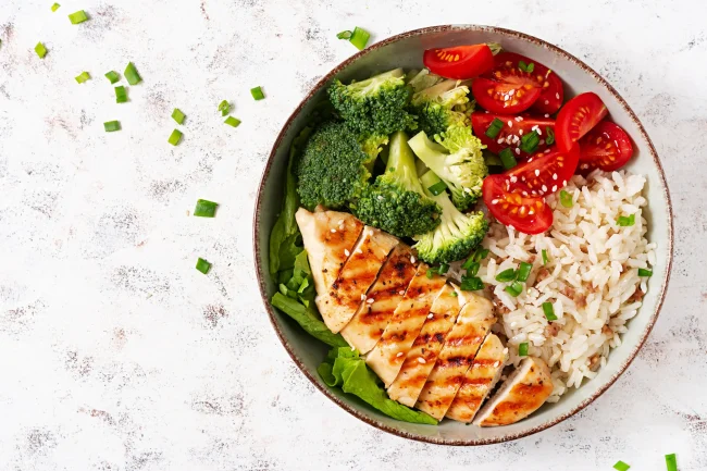 A delicious home-cooked meal of grilled chicken, rice and vegetables. A delicious home-cooked meal of grilled chicken, rice and vegetables.